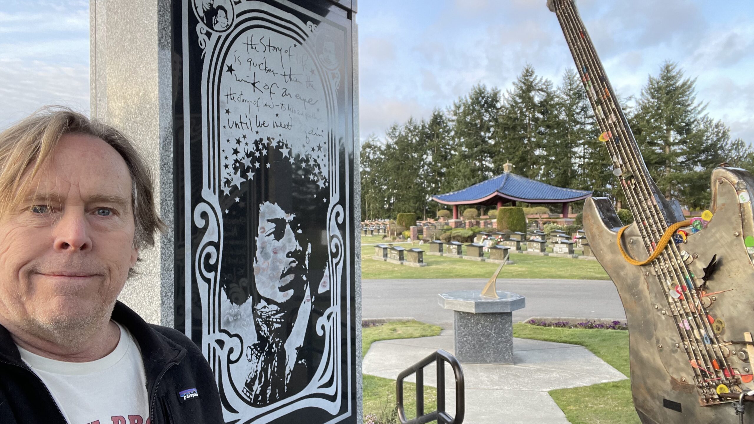 Todd at the Jimi Hendrix memorial with art of Jimi Hendrix.