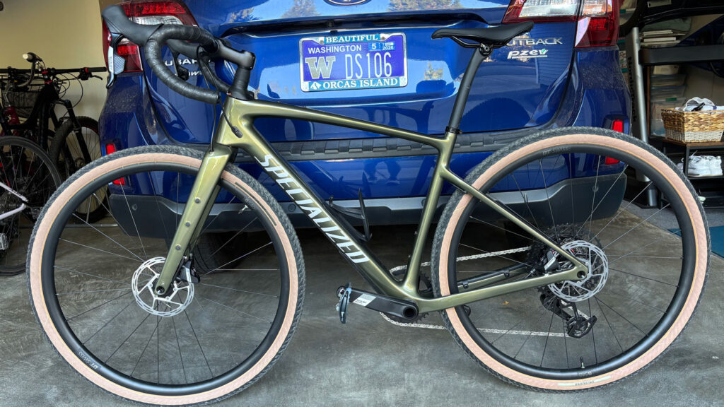 A Specialized Diverge bike leaning against a car.
