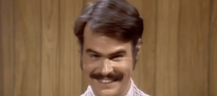 Dan Akroyd smiling mischievously.